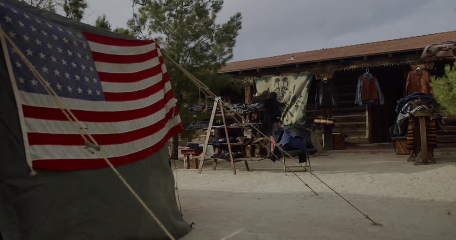 An american flag is posted on the side of a tent