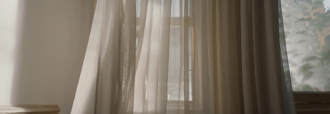 The curtains blow from the wind