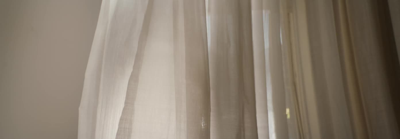 The curtain is blowing in the wind
