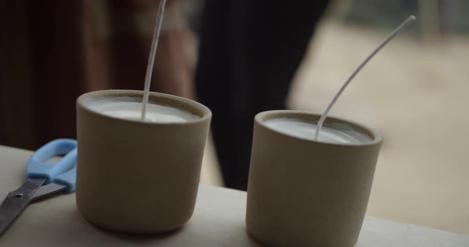 Scissors sit next to candles with long wicks