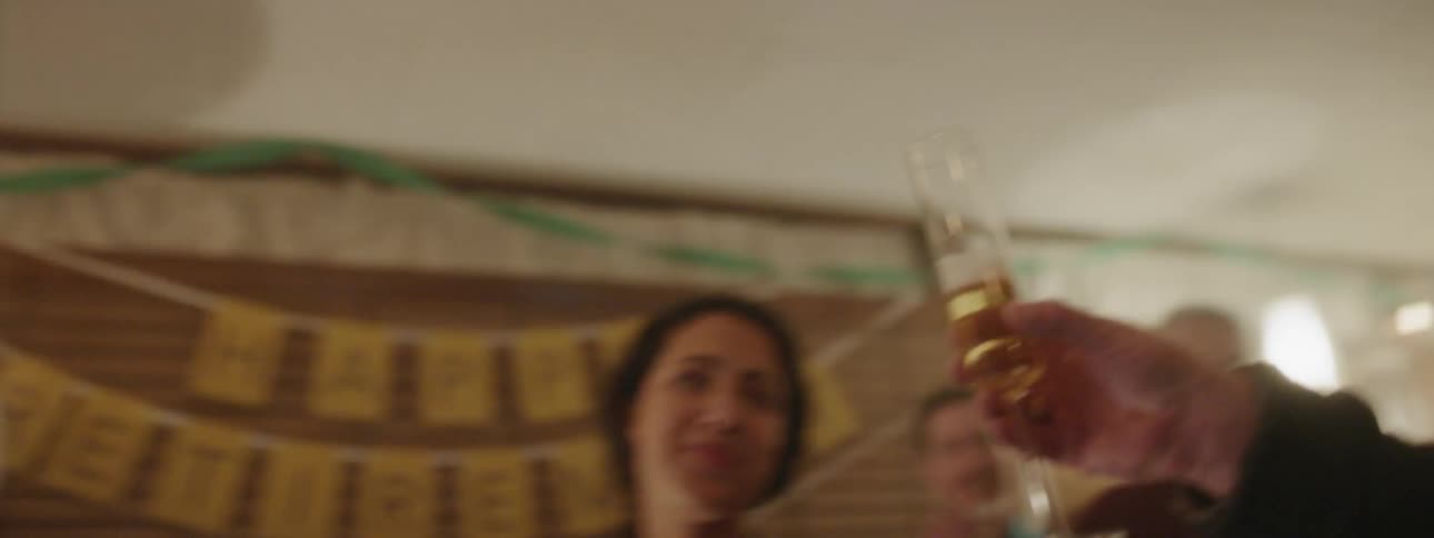 Group of people make a toast then drink from their slender glasses