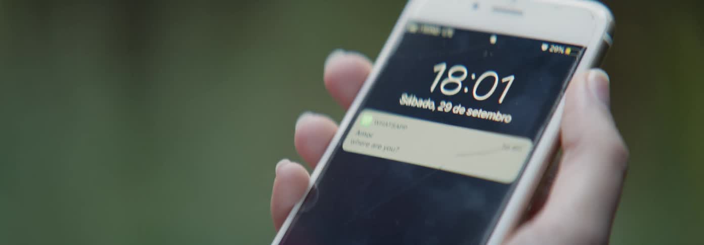A person lifts their phone up to check it