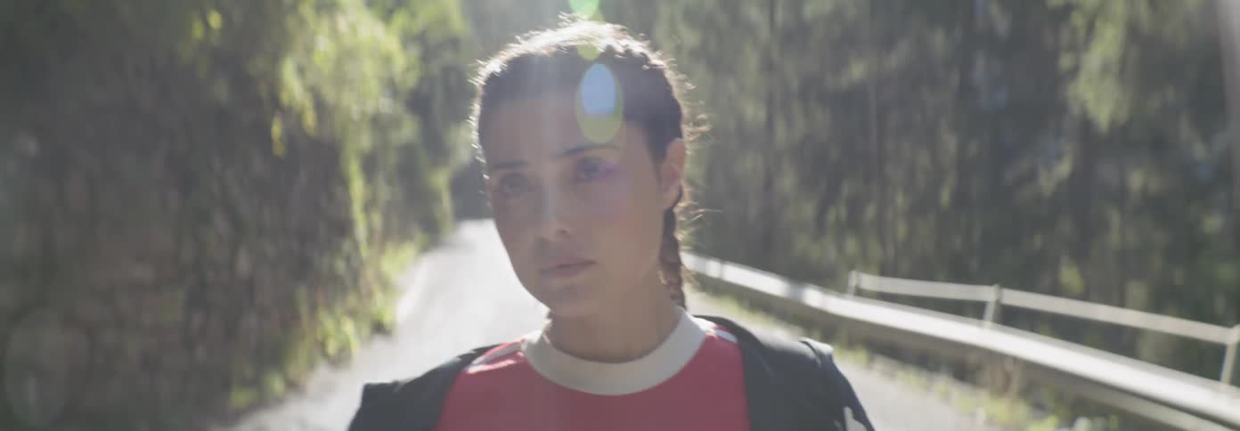 Woman walks on a forest road
