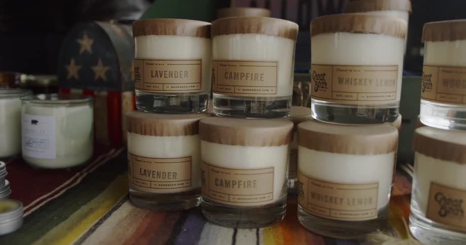 The table is stacked with many jars