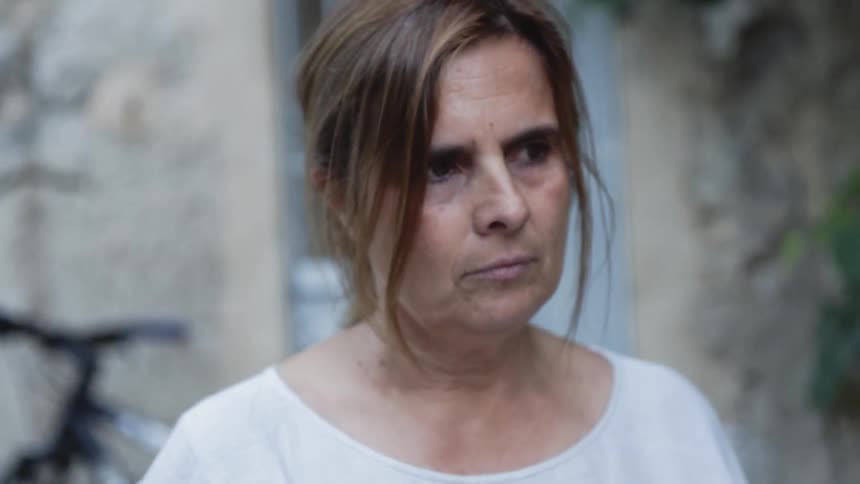 Woman blinks her eyes as she stares ahead