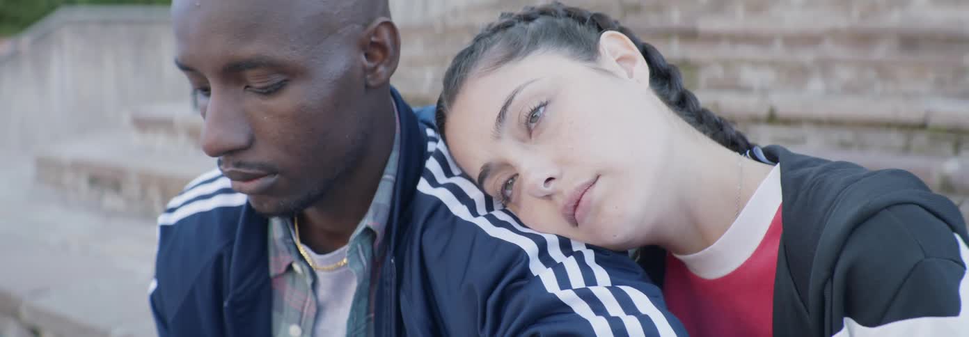 A woman rests on a man's shoulder
