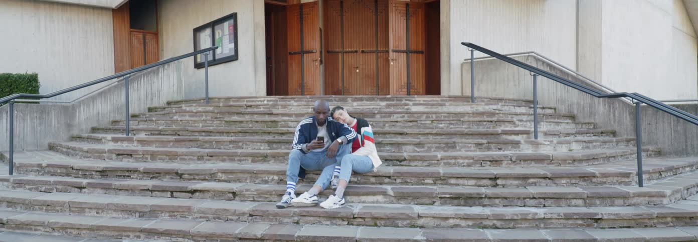 A man and woman sit on the steps together