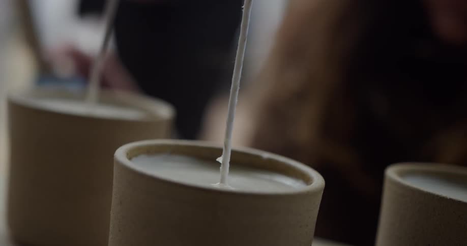 A man taps the candles with a pair of scissors