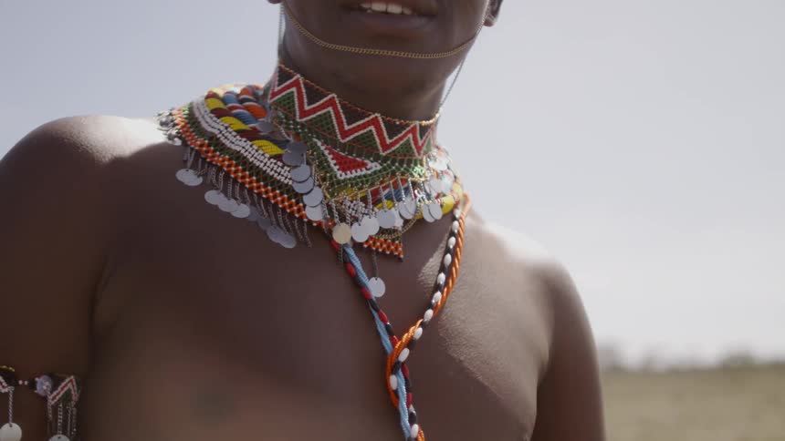 Man wears an ornate necklace and armband