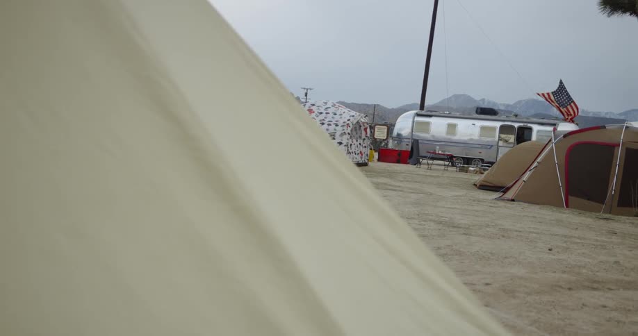 Tents and a camper in a desert