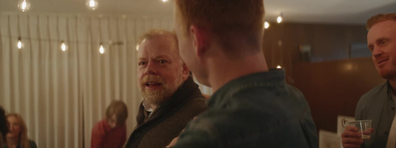 Man smile and talk at a party