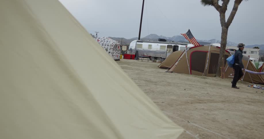 Several tents outside in a campsite in the desert