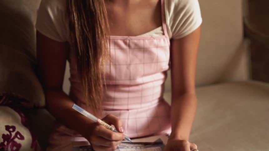 Woman writes on a paper