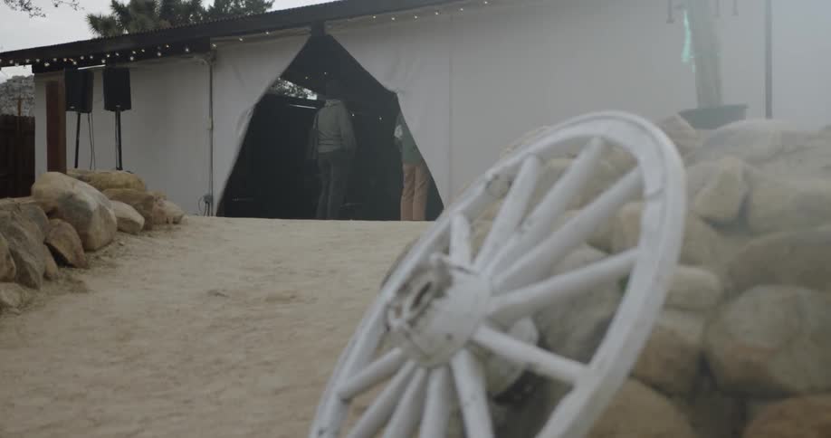 The wooden wheel leans against the rocks