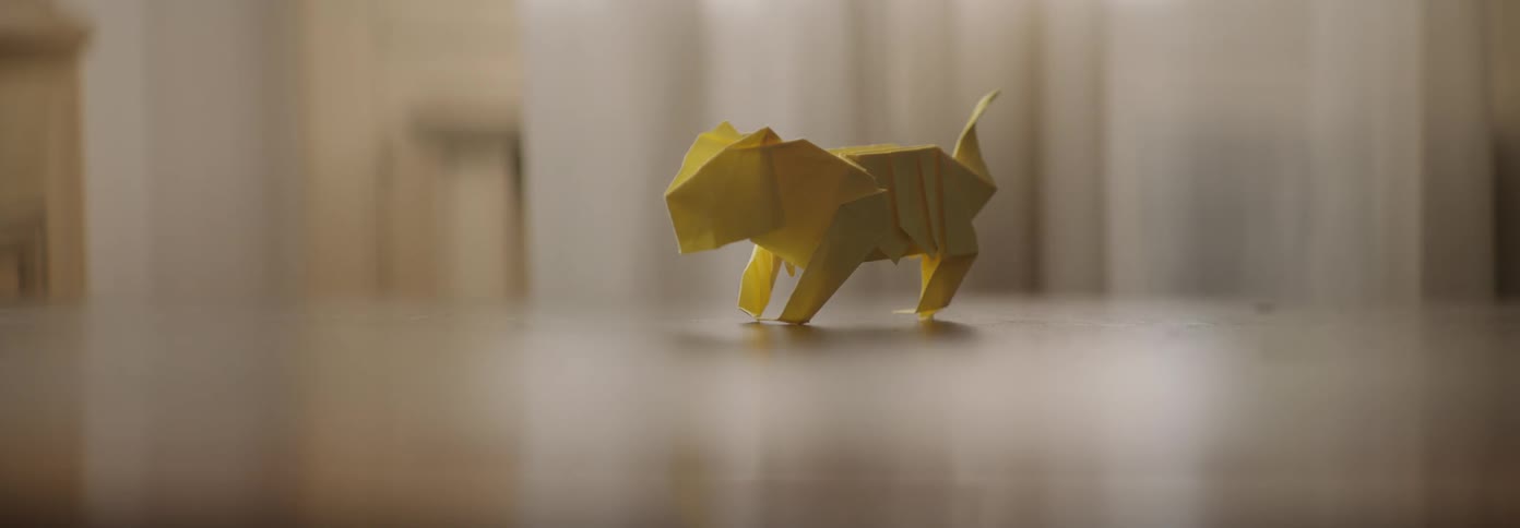 A small paper animal sits on the table