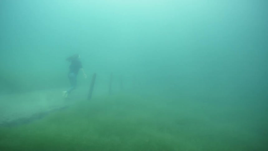 Woman jogs underwater on a path