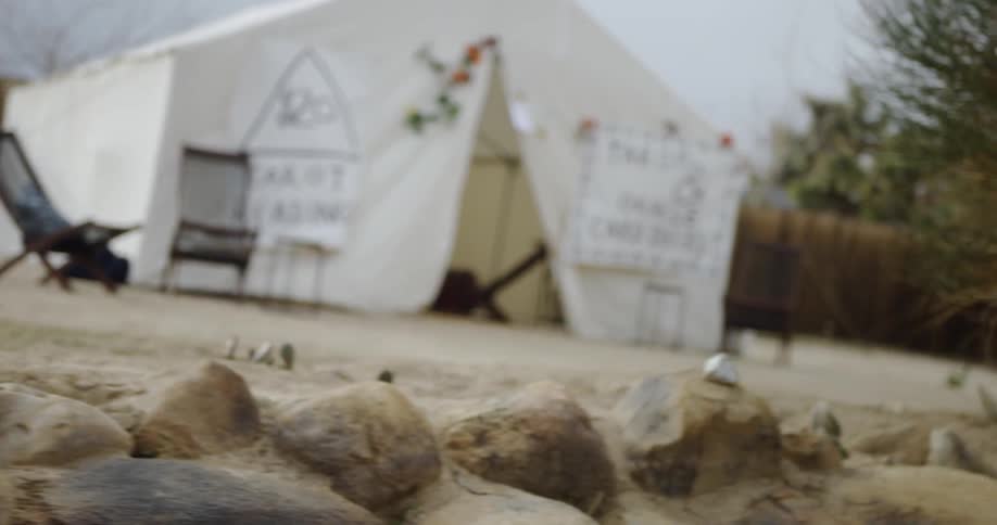 Rocks cover the ground near a tent
