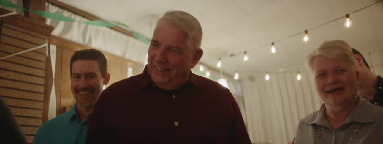 People smile at a retirement party