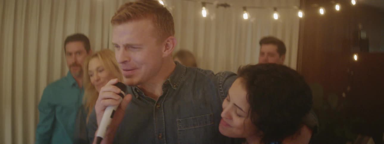 Man sings karaoke at a house party