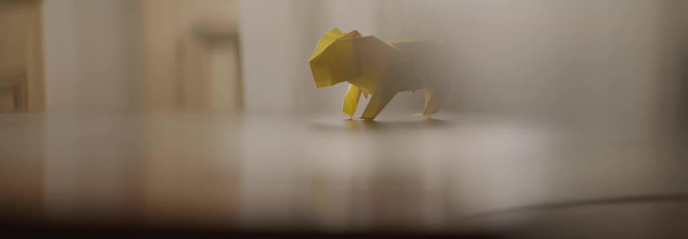 A yellow paper figure sits on the counter