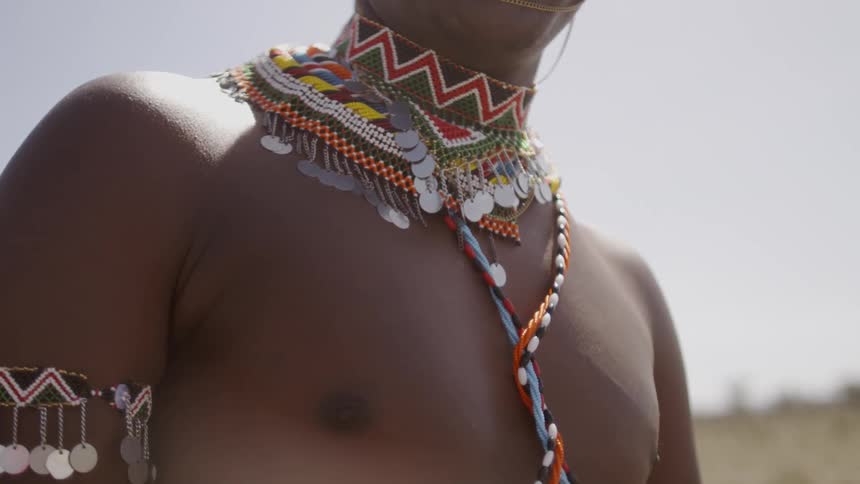 A man is wearing tribal attire on the field