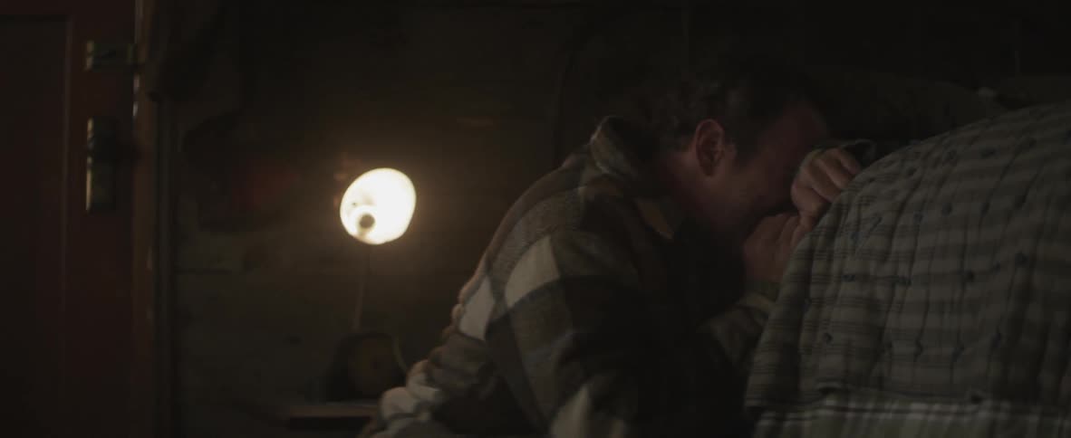 Distressed man falls to the floor near a bed