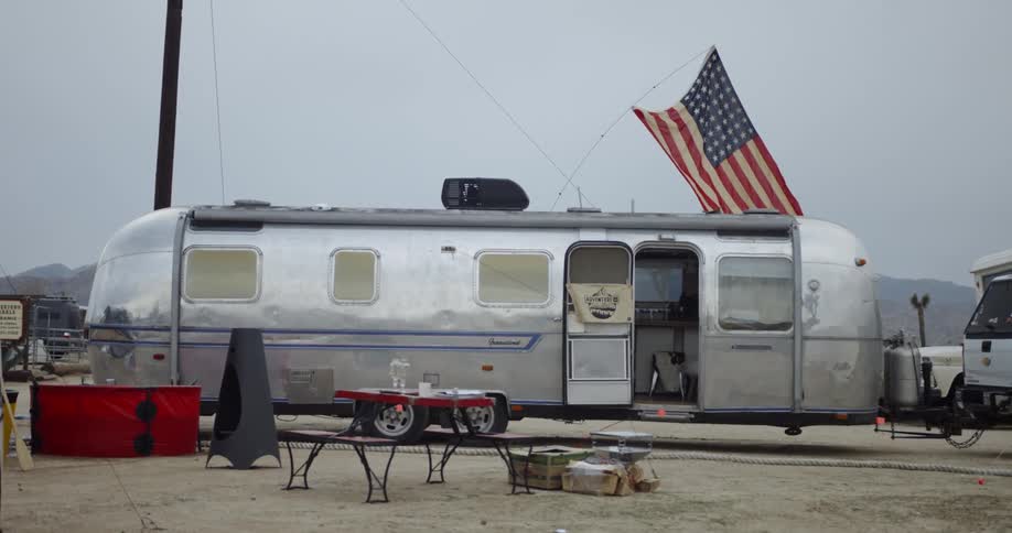 The flag blows in the wind on the silver trailer