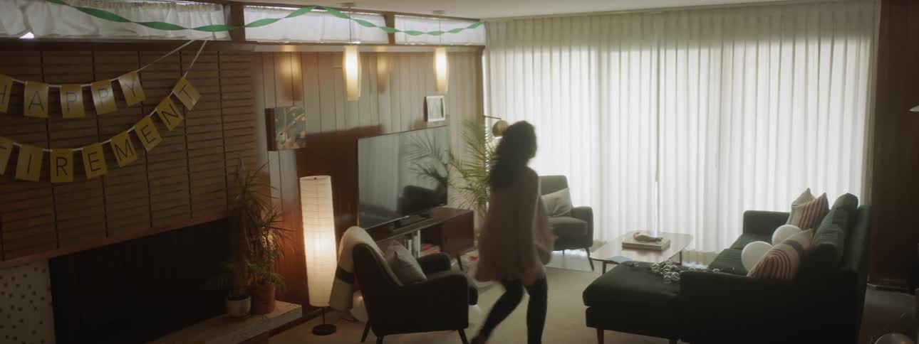 A woman walks around the living room