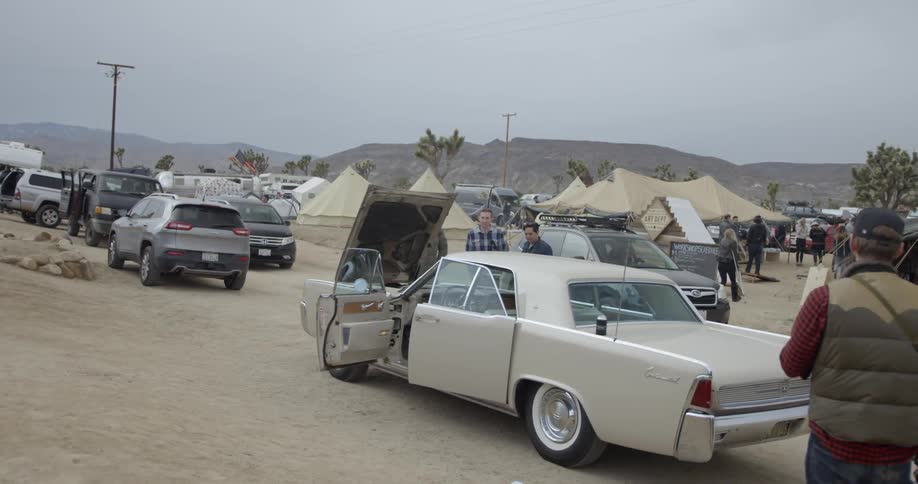 People park their cars near the tents