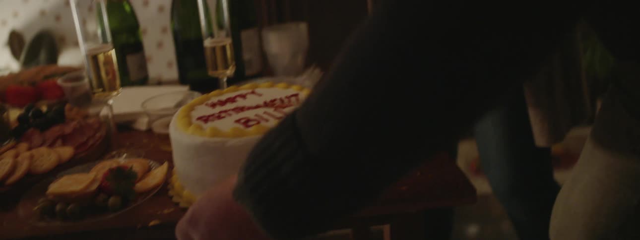 Man cuts a cake at a retirement party