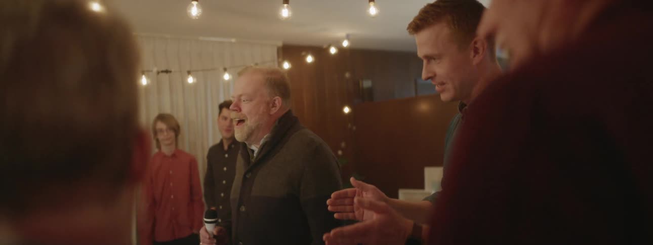 People sing karaoke at a house party
