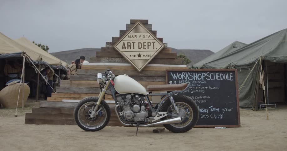A motorcycle is parked at an outdoor festival
