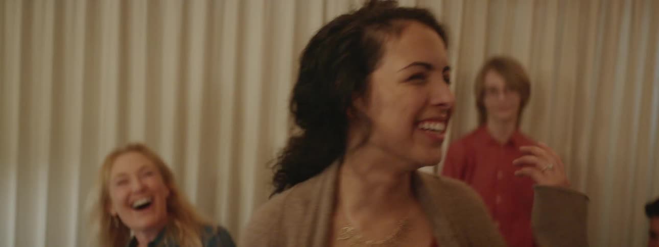 A woman laughs and has fun at a party