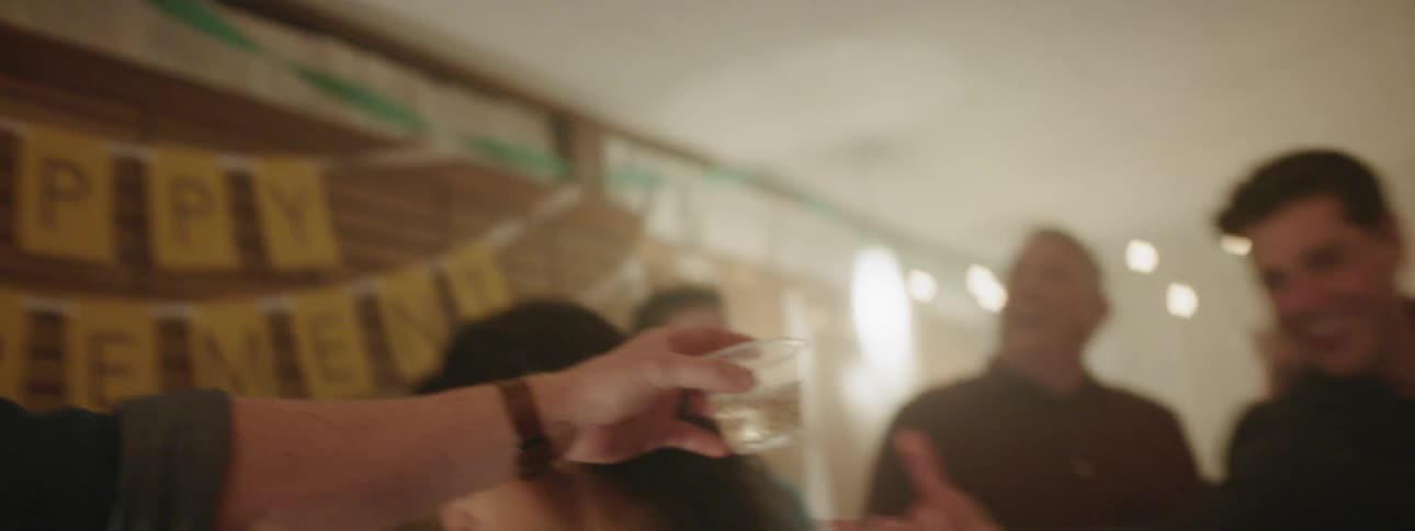 The group of people gather together at the party for drinks