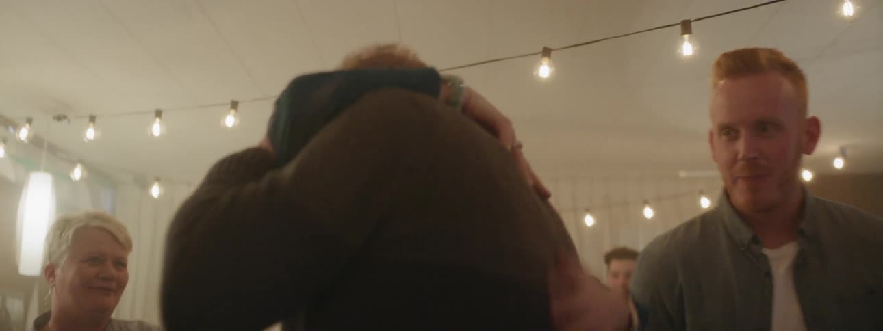 A woman hugs a man and congratulates him during a party