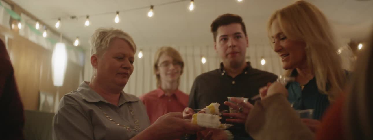 People at party pass around slices of cake