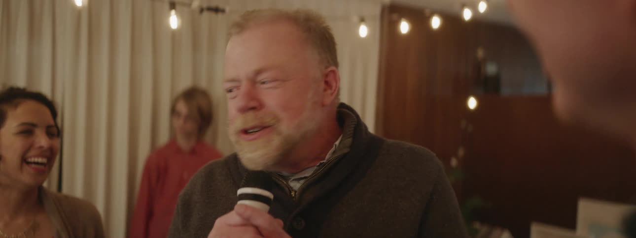 Man sings karaoke at a house party