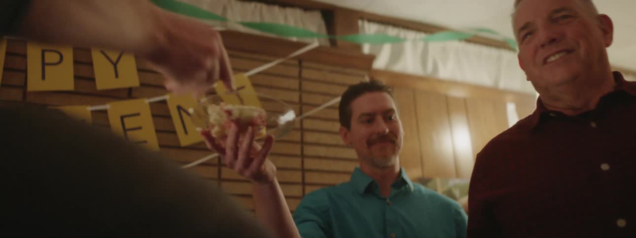 Pieces of cake are passed out at a party