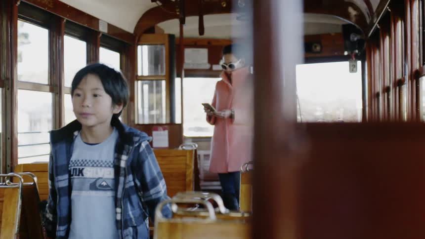 Woman and child stand on a trolley