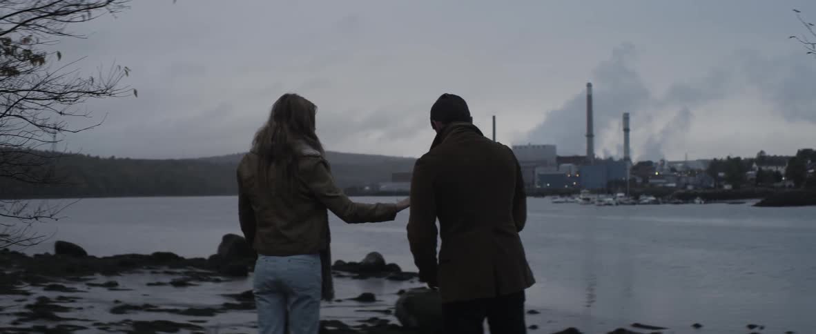 A couple standing on a rocky beach