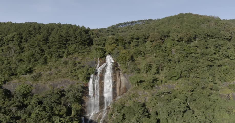 Waterfalls flow over a cliff in mountains