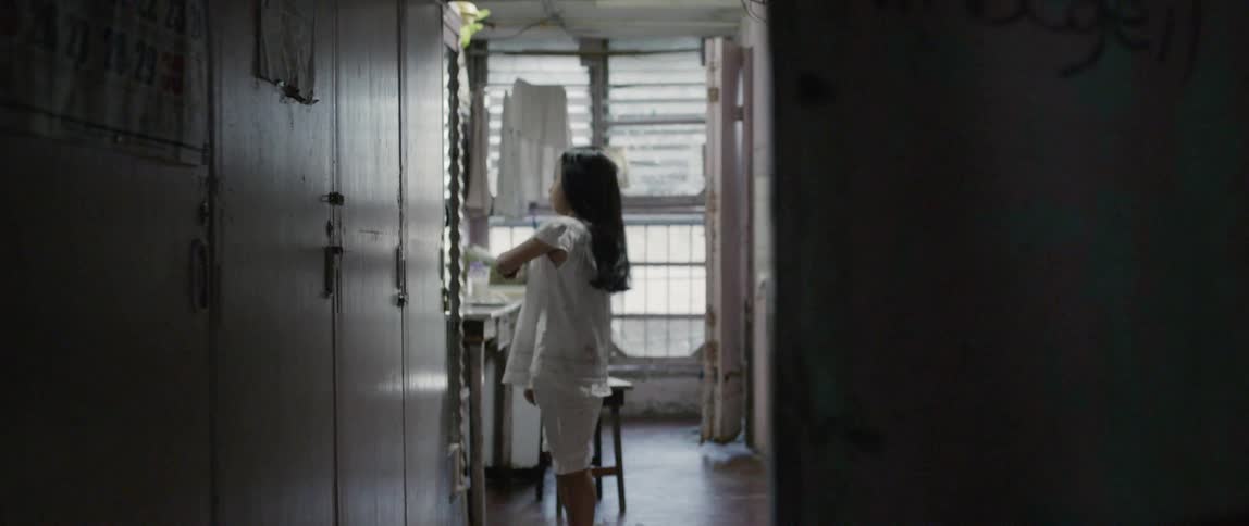 A young girl brushes her hair