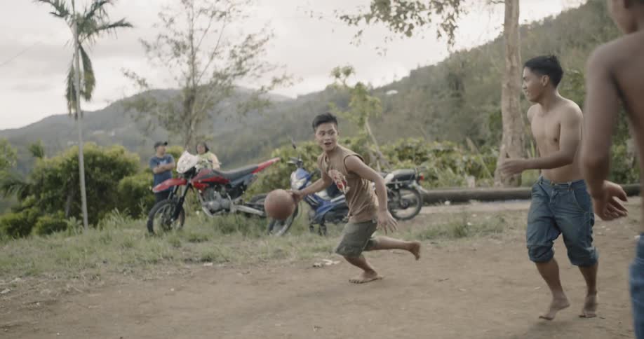 A group of young men play basketball