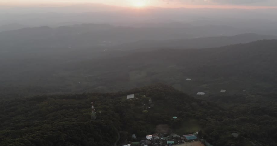 A small town sits on the foggy hills