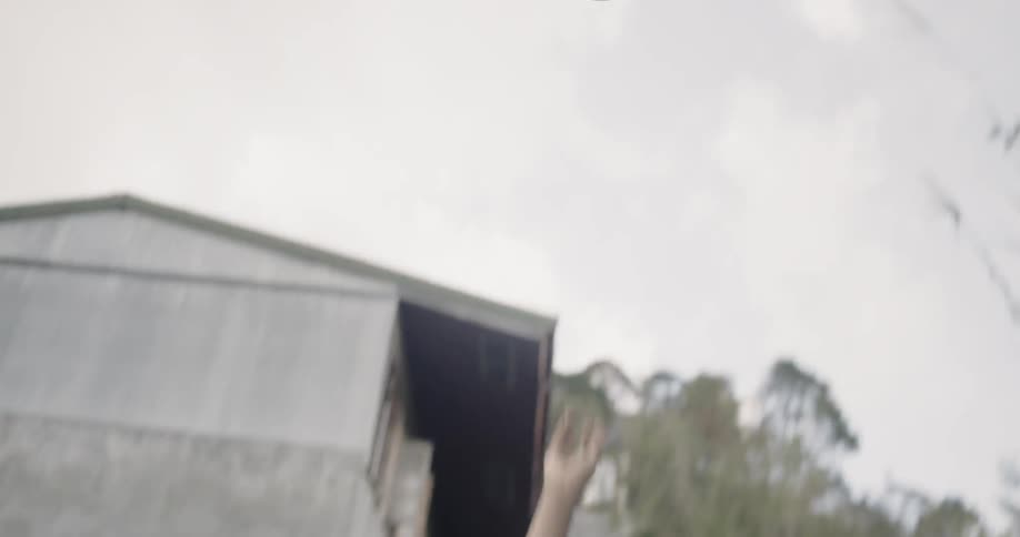 Young boy plays basketball on a dirt court