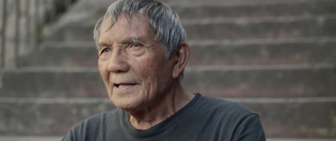 Man sits on an outside staircase