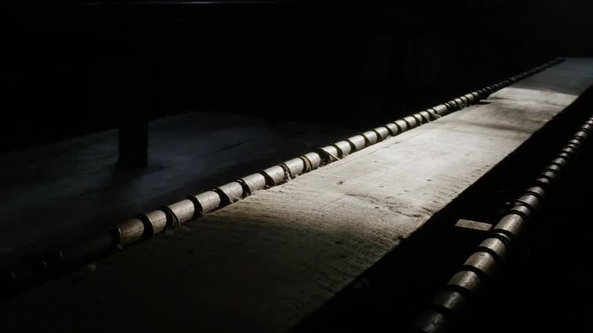 The conveyor belt is in the dark