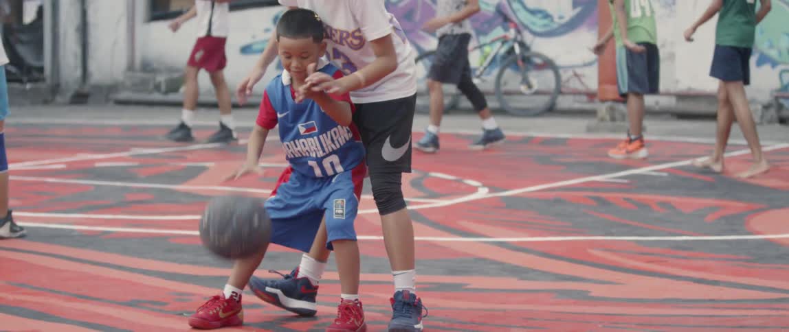 The children play basketball all over the court