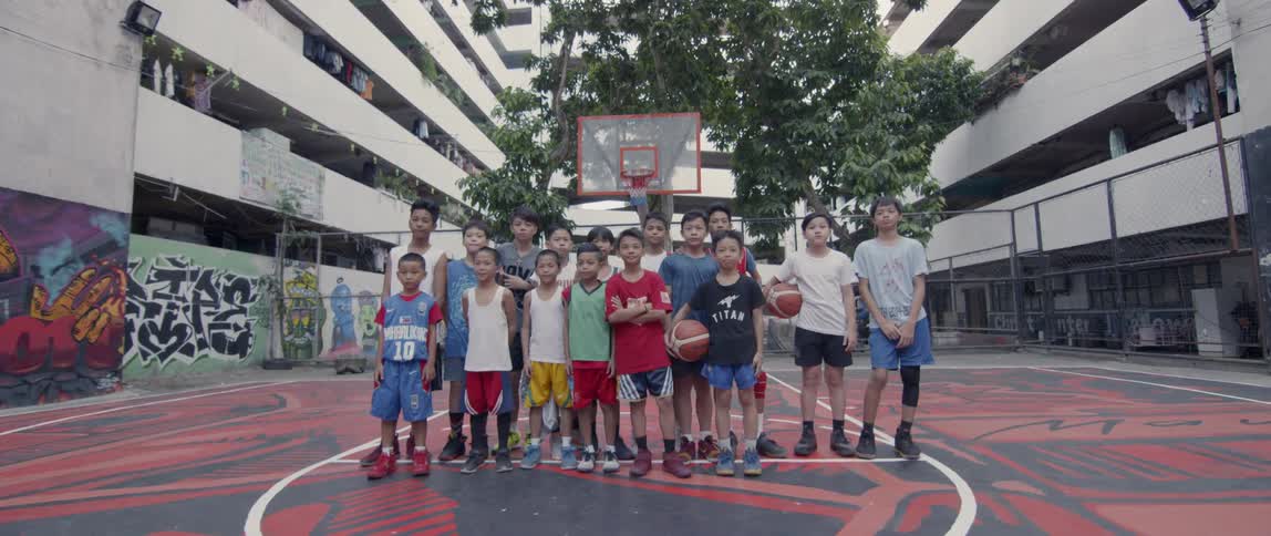 A young boys basketball team stands together and poses
