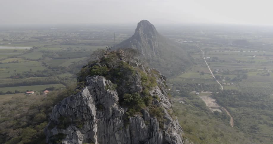 Hiker stands on a mountain peak